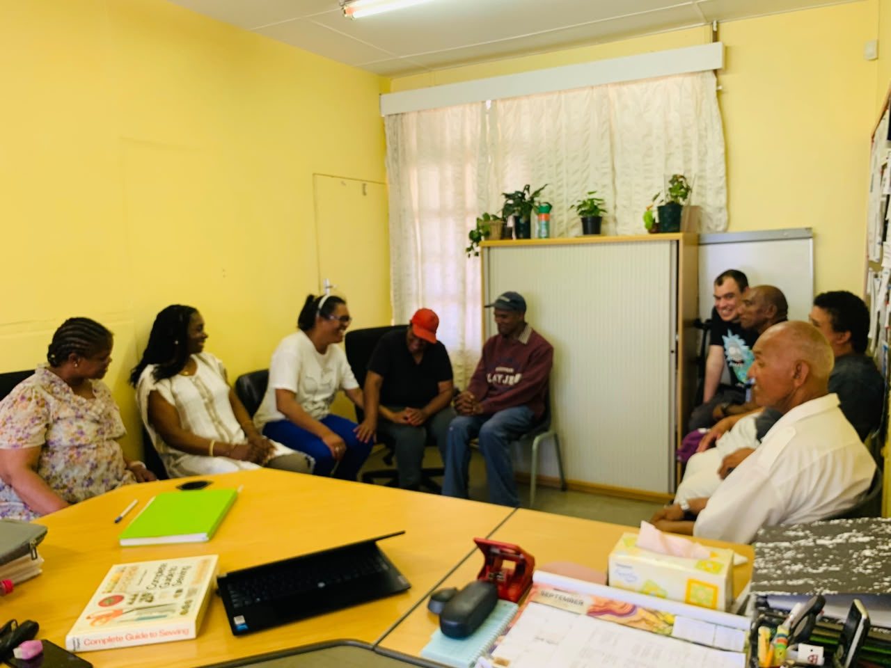 Residents and staff sitting together in a representative group meeting